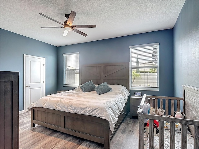 140 Trinity Ridge Cir, Davenport, FL 33897 - bedroom with wood finished floors, a textured ceiling, and ceiling fan