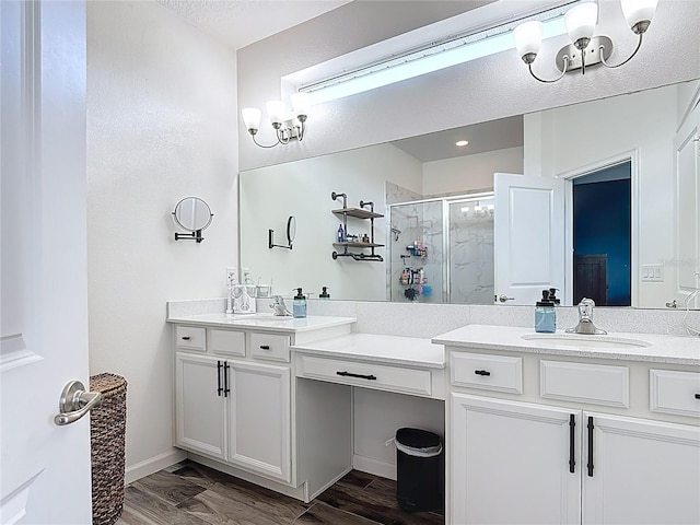 140 Trinity Ridge Cir, Davenport, FL 33897 - bathroom featuring a shower stall, double vanity, and a chandelier