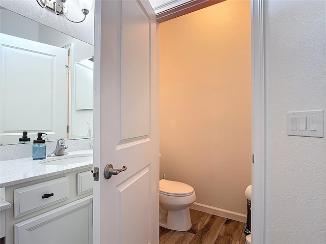 140 Trinity Ridge Cir, Davenport, FL 33897 - bathroom with toilet, wood finished floors, vanity, and baseboards