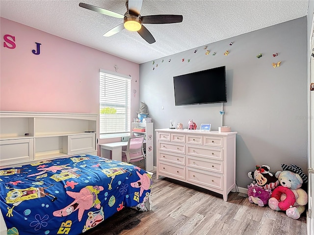 140 Trinity Ridge Cir, Davenport, FL 33897 - bedroom featuring light wood finished floors, a textured ceiling, and ceiling fan