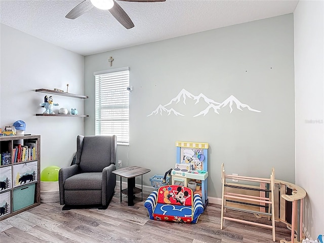 140 Trinity Ridge Cir, Davenport, FL 33897 - recreation room featuring wood finished floors, a ceiling fan, and a textured ceiling