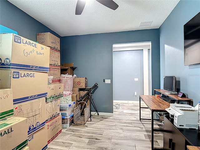140 Trinity Ridge Cir, Davenport, FL 33897 - office space with ceiling fan, wood finished floors, a textured ceiling, and baseboards
