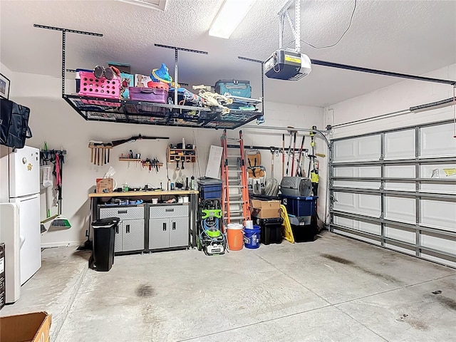 140 Trinity Ridge Cir, Davenport, FL 33897 - garage featuring freestanding refrigerator and a garage door opener
