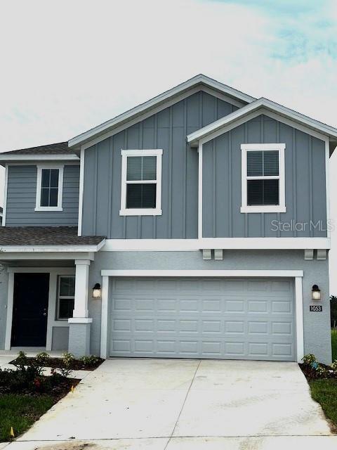 view of front facade featuring board and batten siding, a garage, and concrete driveway
