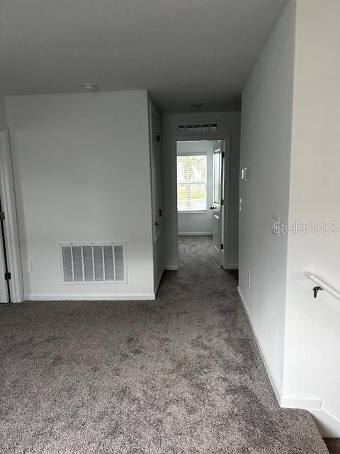 hall with carpet and baseboards