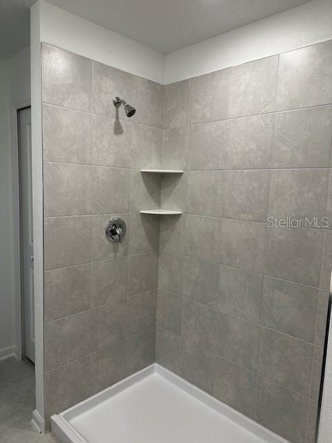 bathroom with tiled shower