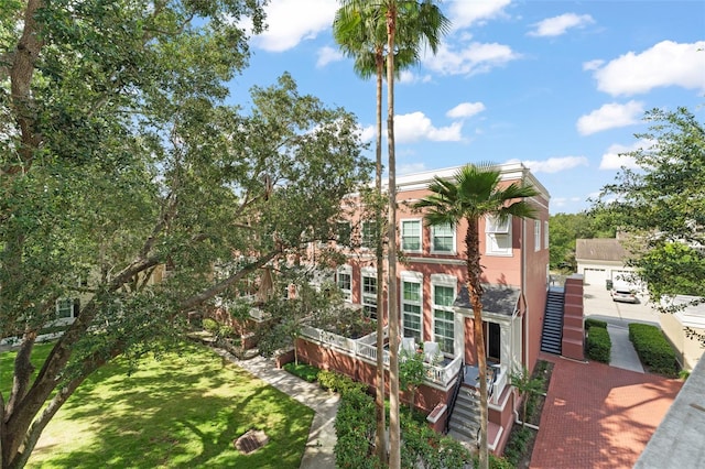 438 Water St Unit 438, Celebration, FL 34747 - view of front of house featuring stairway and a front lawn