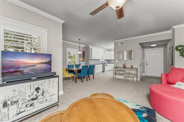 438 Water St Unit 438, Celebration, FL 34747 - living area featuring crown molding, ceiling fan, and carpet