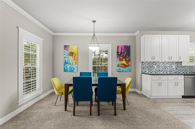 438 Water St Unit 438, Celebration, FL 34747 - dining room with healthy amount of natural light, crown molding, and light wood-style floors