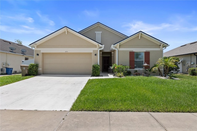 view of front of home featuring stucco siding, a garage, driveway, and a front lawn