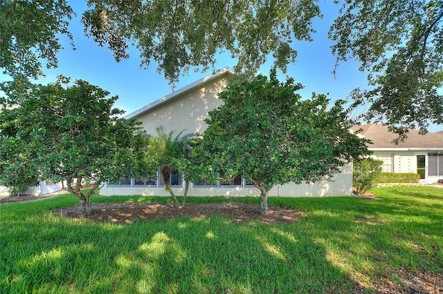 124 Ashton Dr, Davenport, FL 33837 - view of side of home featuring a lawn and stucco siding