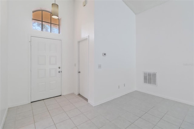 3370 Cypress Point Cir, Saint Cloud, FL 34772 - entrance foyer featuring baseboards, light tile patterned floors, and a high ceiling