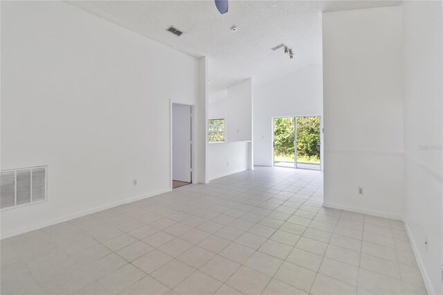 3370 Cypress Point Cir, Saint Cloud, FL 34772 - empty room featuring high vaulted ceiling, light tile patterned floors, baseboards, and ceiling fan