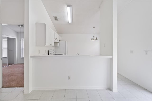 3370 Cypress Point Cir, Saint Cloud, FL 34772 - kitchen featuring vaulted ceiling, freestanding refrigerator, light countertops, range, and a peninsula