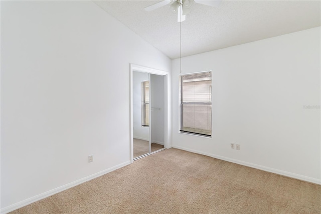 3370 Cypress Point Cir, Saint Cloud, FL 34772 - unfurnished bedroom featuring light carpet, baseboards, lofted ceiling, and a ceiling fan