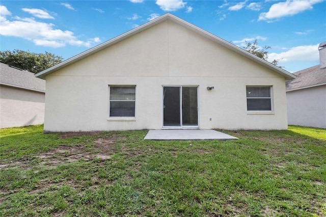 3370 Cypress Point Cir, Saint Cloud, FL 34772 - rear view of property with a patio, a yard, and stucco siding