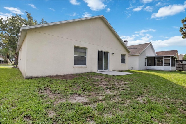 3370 Cypress Point Cir, Saint Cloud, FL 34772 - back of house featuring a sunroom, a lawn, a patio, and stucco siding