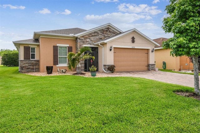 1272 Bonita Canyon Dr, Kissimmee, FL 34759 - view of front of home featuring stone siding, stucco siding, and decorative driveway