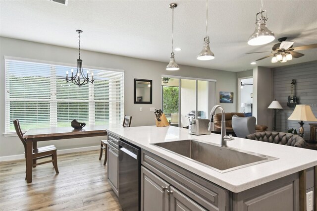 1272 Bonita Canyon Dr, Kissimmee, FL 34759 - kitchen featuring a sink, dishwasher, light countertops, light wood-style floors, and open floor plan