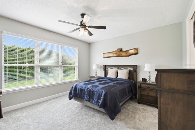 1272 Bonita Canyon Dr, Kissimmee, FL 34759 - bedroom featuring baseboards, light colored carpet, ceiling fan, and a textured ceiling