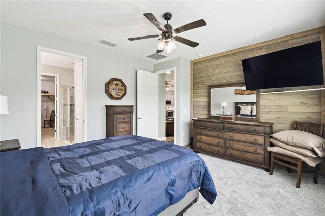 1272 Bonita Canyon Dr, Kissimmee, FL 34759 - bedroom with wooden walls, light colored carpet, ceiling fan, and ensuite bath