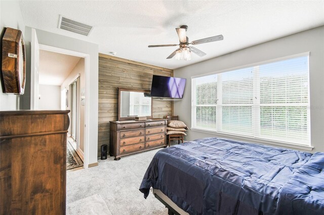 1272 Bonita Canyon Dr, Kissimmee, FL 34759 - carpeted bedroom with wooden walls and a ceiling fan