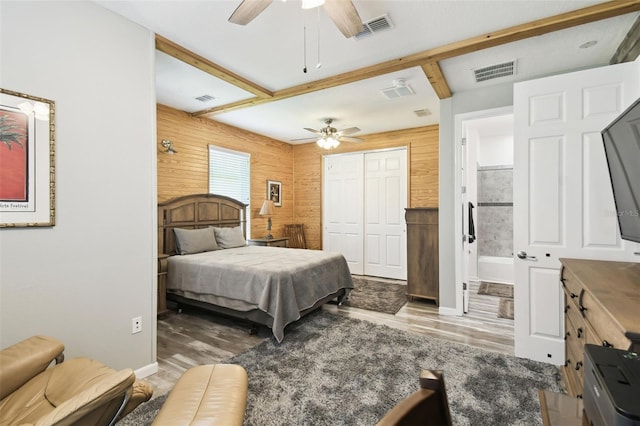 1272 Bonita Canyon Dr, Kissimmee, FL 34759 - bedroom featuring wood finished floors, baseboards, wooden walls, a closet, and ensuite bathroom