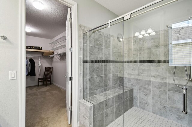 1272 Bonita Canyon Dr, Kissimmee, FL 34759 - full bath featuring a stall shower, a textured ceiling, and a spacious closet