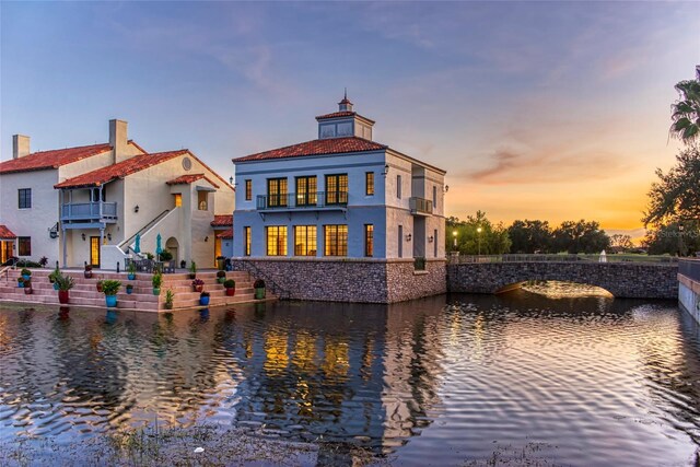 1272 Bonita Canyon Dr, Kissimmee, FL 34759 - back of property featuring a water view, a balcony, and stucco siding