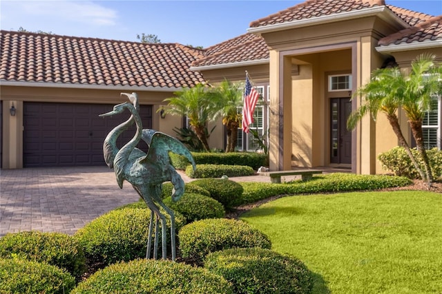7 Spanish Moss Ct, Palm Coast, FL 32137 - view of front of property with a tile roof, a garage, stucco siding, driveway, and a front yard