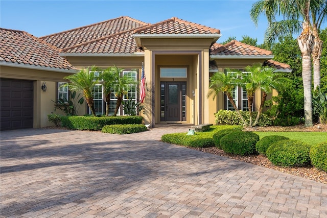 7 Spanish Moss Ct, Palm Coast, FL 32137 - view of front of house with a garage, decorative driveway, a tile roof, and stucco siding