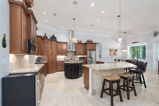 7 Spanish Moss Ct, Palm Coast, FL 32137 - kitchen with a large island with sink, appliances with stainless steel finishes, wall chimney range hood, a sink, and backsplash