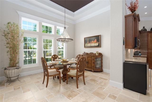 7 Spanish Moss Ct, Palm Coast, FL 32137 - dining room with ornamental molding, a high ceiling, stone tile flooring, a chandelier, and baseboards