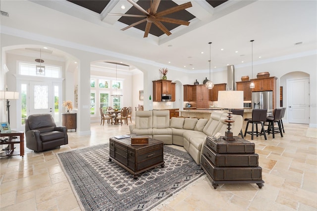 7 Spanish Moss Ct, Palm Coast, FL 32137 - living area with arched walkways, stone tile flooring, coffered ceiling, a towering ceiling, and recessed lighting
