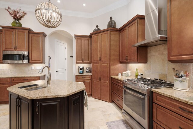 7 Spanish Moss Ct, Palm Coast, FL 32137 - kitchen with wall chimney range hood, appliances with stainless steel finishes, a sink, light stone counters, and arched walkways