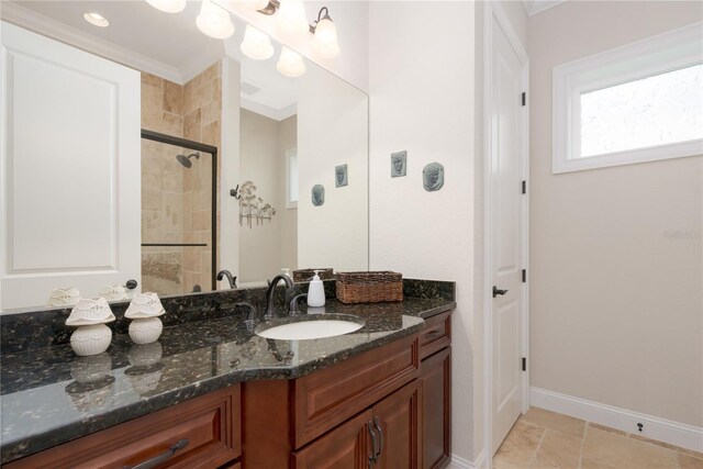 7 Spanish Moss Ct, Palm Coast, FL 32137 - bathroom with vanity, a tile shower, baseboards, and crown molding