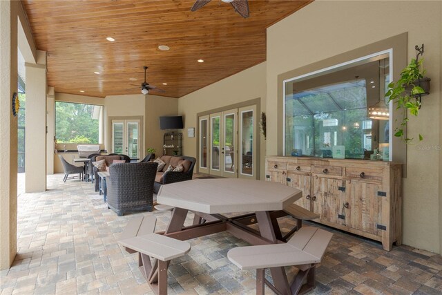 7 Spanish Moss Ct, Palm Coast, FL 32137 - view of patio featuring french doors, an outdoor kitchen, a ceiling fan, an outdoor living space, and outdoor dining area