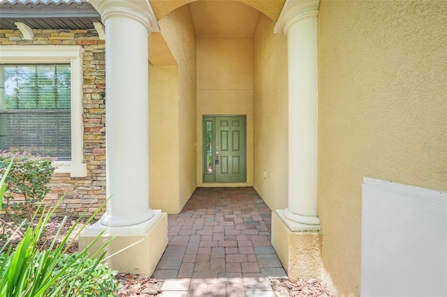 1300 Island Green St, Davenport, FL 33896 - doorway to property featuring stone siding and stucco siding