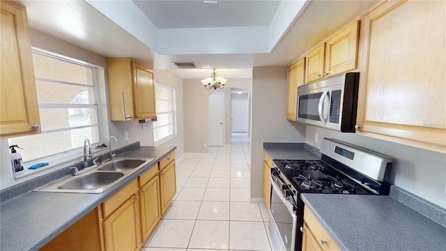 114 N Alderwood St, Winter Springs, FL 32708 - kitchen featuring stainless steel appliances, light brown cabinetry, a sink, a tray ceiling, and dark countertops
