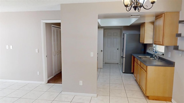 114 N Alderwood St, Winter Springs, FL 32708 - kitchen featuring a sink, dark countertops, freestanding refrigerator, a chandelier, and light tile patterned floors