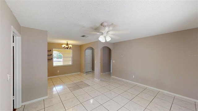 114 N Alderwood St, Winter Springs, FL 32708 - spare room featuring arched walkways, a chandelier, a ceiling fan, light tile patterned flooring, and baseboards