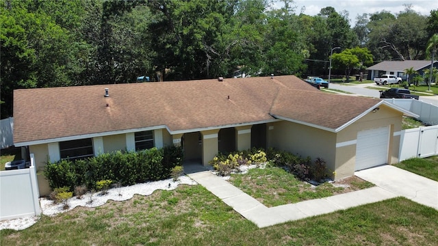 114 N Alderwood St, Winter Springs, FL 32708 - ranch-style home with stucco siding, concrete driveway, an attached garage, and a shingled roof