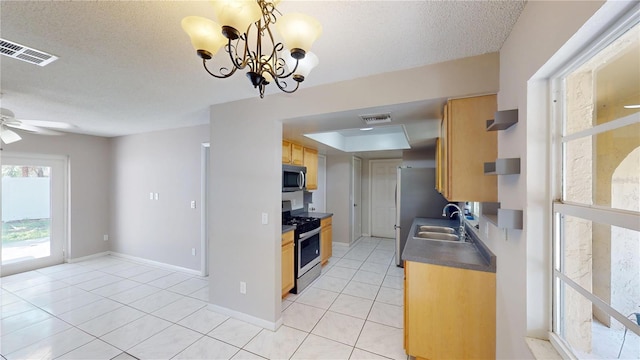 114 N Alderwood St, Winter Springs, FL 32708 - kitchen with appliances with stainless steel finishes, a sink, light tile patterned flooring, dark countertops, and a textured ceiling