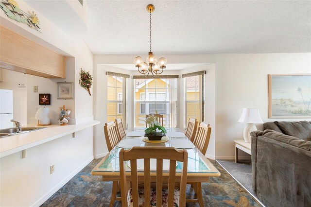 2438 Sweetwater Club Cir Unit 50, Kissimmee, FL 34746 - dining area featuring a textured ceiling, a chandelier, and baseboards