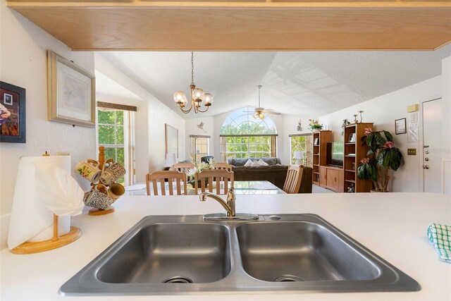 2438 Sweetwater Club Cir Unit 50, Kissimmee, FL 34746 - kitchen with plenty of natural light, light countertops, lofted ceiling, and a chandelier
