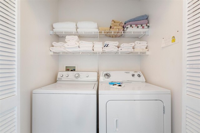 2438 Sweetwater Club Cir Unit 50, Kissimmee, FL 34746 - laundry area with washer and dryer