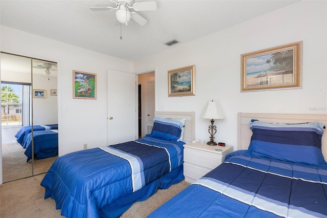 2438 Sweetwater Club Cir Unit 50, Kissimmee, FL 34746 - bedroom with carpet, a closet, a ceiling fan, and a textured ceiling
