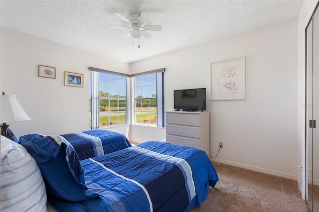 2438 Sweetwater Club Cir Unit 50, Kissimmee, FL 34746 - carpeted bedroom with a textured ceiling, ceiling fan, and baseboards