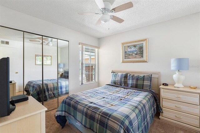 2438 Sweetwater Club Cir Unit 50, Kissimmee, FL 34746 - bedroom with carpet floors, a closet, a textured ceiling, and a ceiling fan