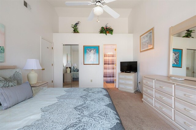 2438 Sweetwater Club Cir Unit 50, Kissimmee, FL 34746 - carpeted bedroom with connected bathroom, a ceiling fan, and a closet